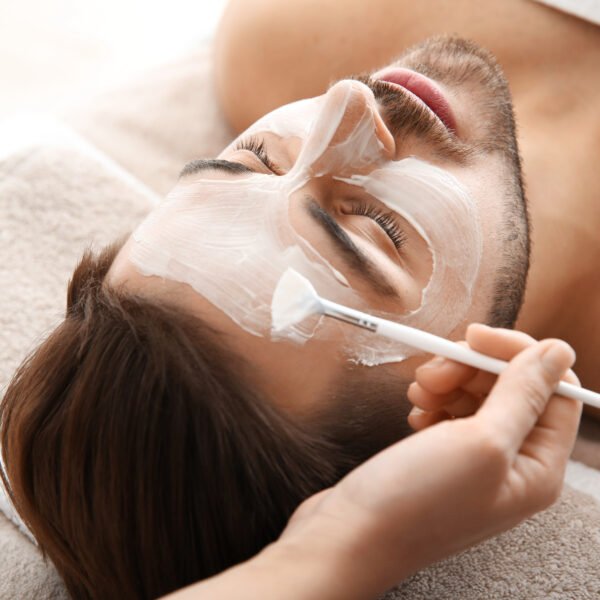 Cosmetologist,Applying,Mask,On,Client's,Face,In,Spa,Salon