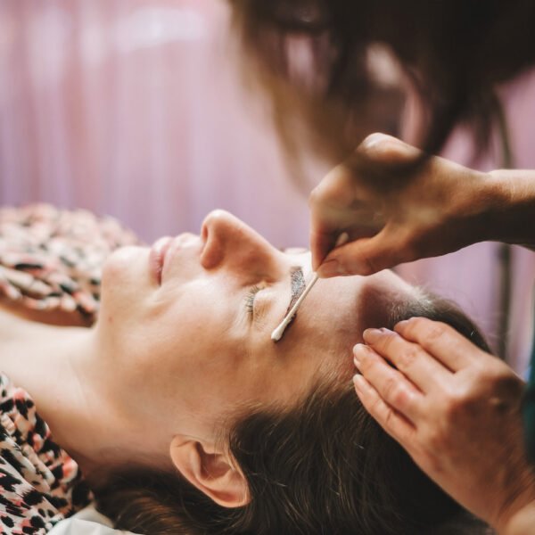Brows - Women getting her left eyebrow tinted with a cotton swab