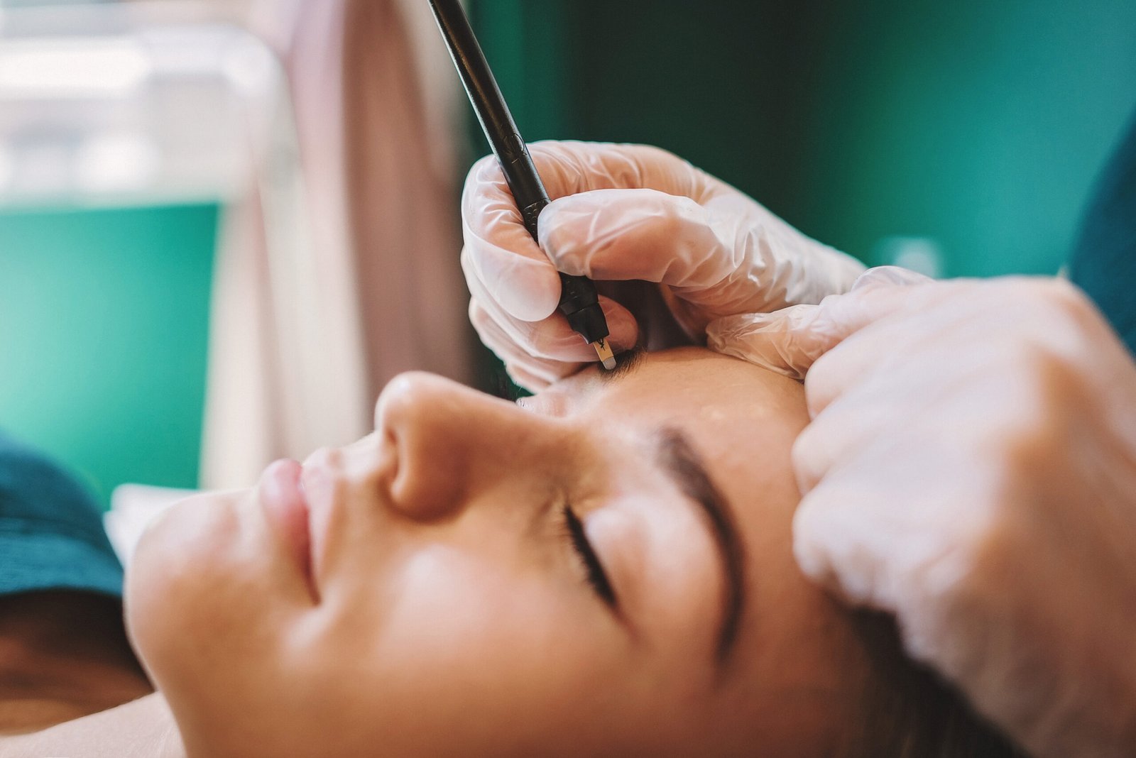 Brows - Women getting some of her right eyebrow hairs removed with tweezers