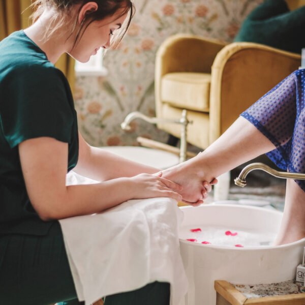 Pedicure - close up of a woman getting her foot taken out of a foot tub